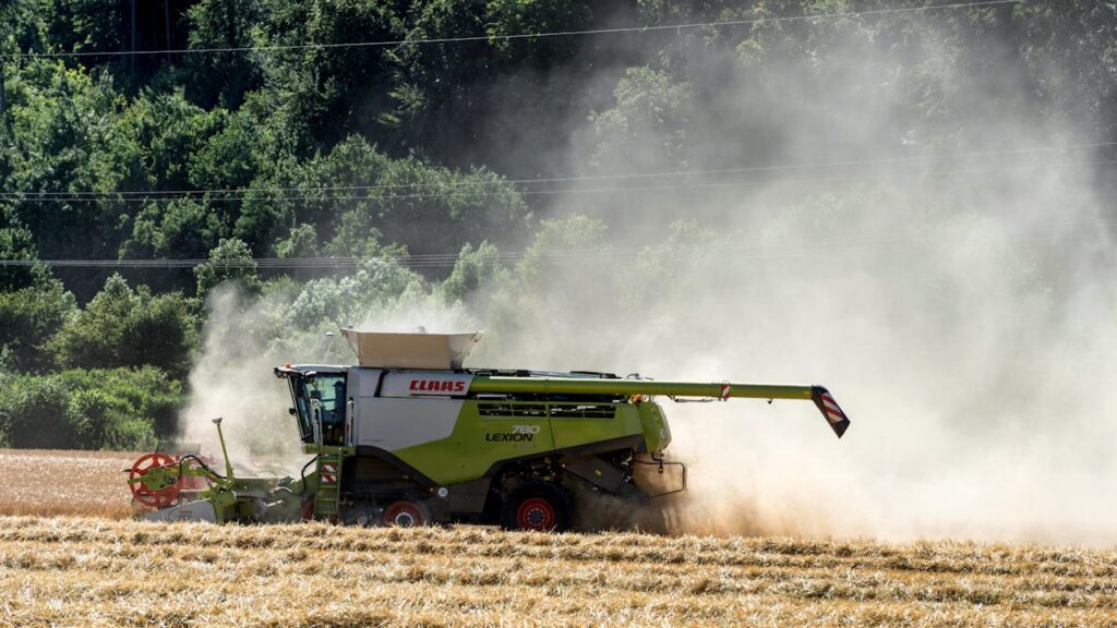 Combine harvester working in a dusty wheat field in Höxter, Germany.
